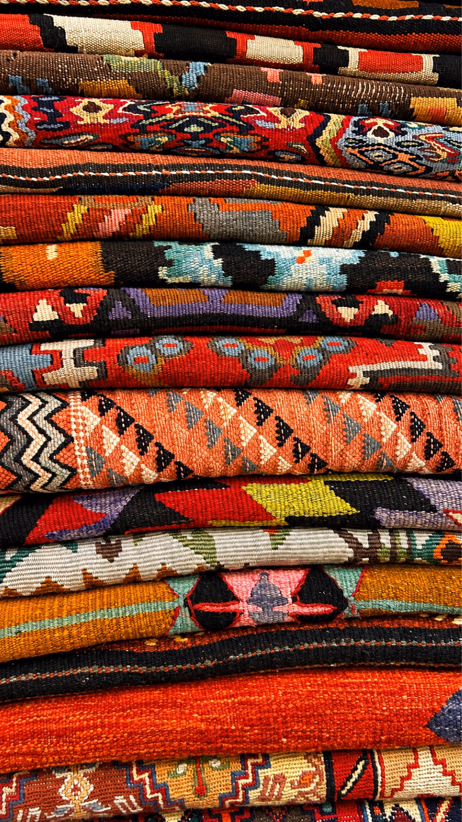 Stack of folded patterned rugs
